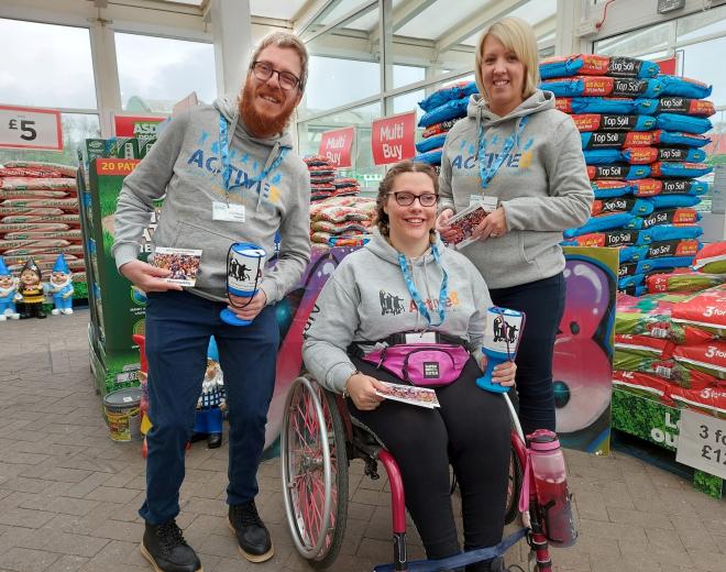 Three Volunteer fundraisers with donations buckets.